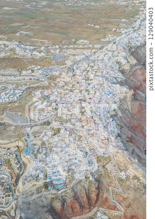 Aerial top view of Cycladic white houses in Oia, Santorini from a drone Aerial top view of Cycladic white houses in Oia, Santorini from a drone 129040403