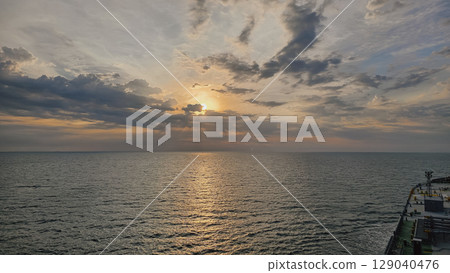 Cargo ship at sunset, view from bridge, maritime trade 129040476