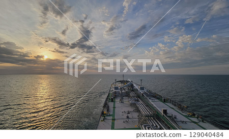 Cargo ship at sunset, view from bridge, maritime trade 129040484