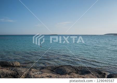 Red Safety Buoys Floating in Clear Blue Water at Rocky Entrance of Elafonisi Beach, Crete Red Safety Buoys Floating in Clear Blue Water at Rocky Entrance of Elafonisi Beach, Crete 129040587