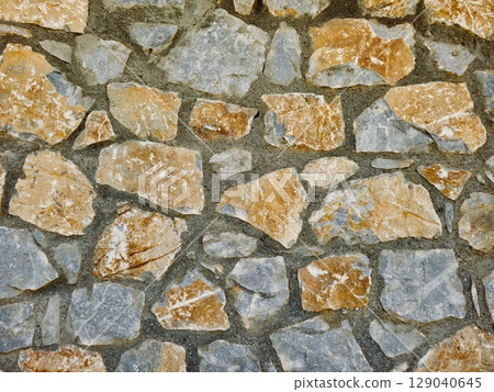 Stone wall texture background with natural masonry and cement joints Stone wall texture background with natural masonry and cement joints 129040645