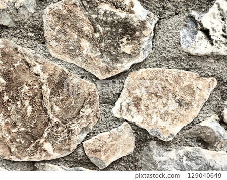 Stone wall texture background with natural masonry and cement joints Stone wall texture background with natural masonry and cement joints 129040649