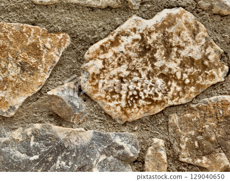 Stone wall texture background with natural masonry and cement joints 129040650