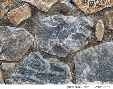 Stone wall texture background with natural masonry and cement joints Stone wall texture background with natural masonry and cement joints 129040663