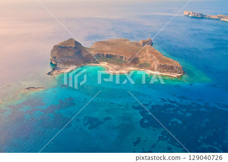Idyllic isolated island with a serene beach near Balos Bay in Crete 129040726