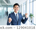 A smiling businessman doing a guts pose 129041018