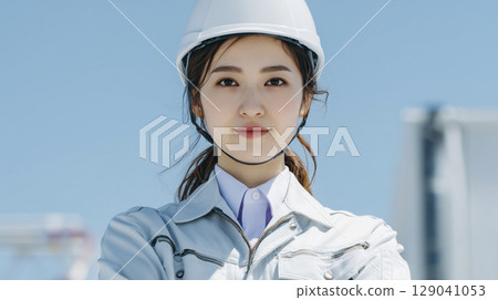 A businesswoman wearing work clothes at a construction site A businesswoman wearing work clothes at a construction site 129041053