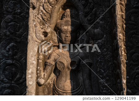 Apsara Bas-Relief decorated in Ta Prohm temple, one of Angkor's best visited monuments. An Apsara is a female spirit from Hindu and Buddhist mythology. 129041199
