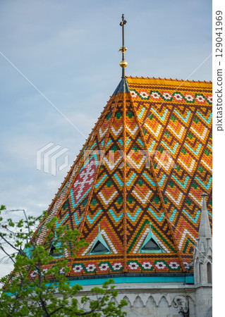 A close-up view of the colorful Zsolnay tiled roof of Matthias Church in Budapest, Hungary A close-up view of the colorful Zsolnay tiled roof of Matthias Church in Budapest, Hungary 129041969
