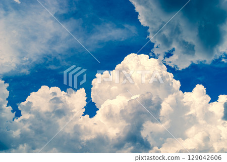 Summer sky with growing cumulonimbus clouds b-4 Warm and cool colors emphasized 129042606