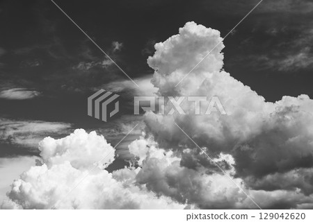 Summer sky with growing cumulonimbus clouds d-6 monochrome 129042620