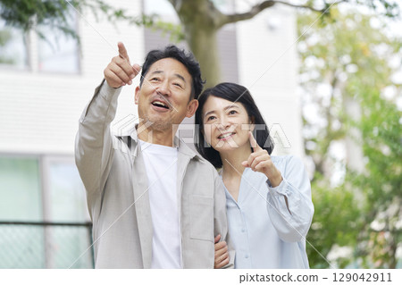 Middle-aged couple taking a walk Middle-aged couple taking a walk 129042911