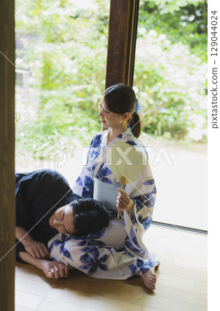 Couple in yukata resting on each other's laps Couple in yukata resting on each other's laps 129044024