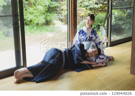 Couple in yukata resting on each other's laps Couple in yukata resting on each other's laps 129044026