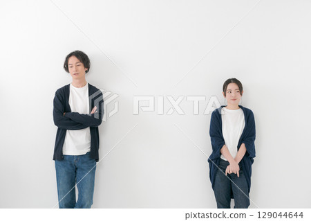 A couple standing side by side with a tense atmosphere 129044644