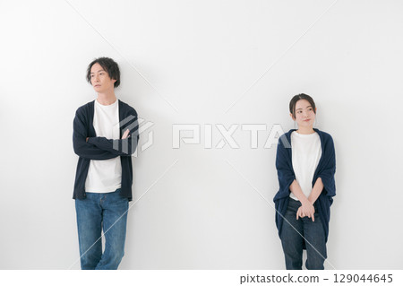 A couple standing side by side with a tense atmosphere A couple standing side by side with a tense atmosphere 129044645