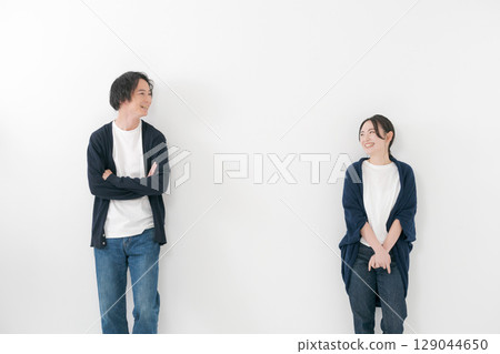 Smiling couple standing side by side Smiling couple standing side by side 129044650