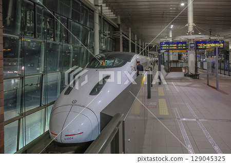 March 25 2025 Bullet Train at Nighttime Station Platform in Urban Setting, Japan 129045325