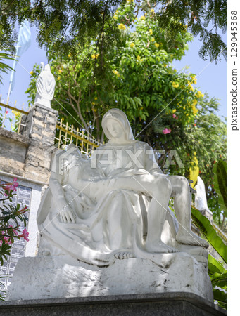 A sculpture of the Virgin Mary and Christ based on Michelangelo's Pieta near the Catholic cathedral 129045368