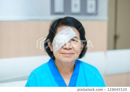 Elderly Woman with eye protective shield after eye surgery. Eye disease, Cataract,  Glaucoma, Age Related Macular Degeneration, Diabetic Retinopathy, Vitreous, Lasik, World Glaucoma day and health 129045520