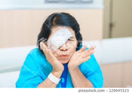 Elderly Woman with eye protective shield after eye surgery. Eye disease, Cataract,  Glaucoma, Age Related Macular Degeneration, Diabetic Retinopathy, Vitreous, Lasik, World Glaucoma day and health 129045523