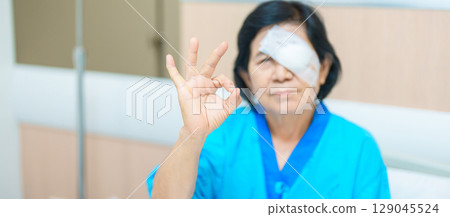 Elderly Woman with eye protective shield after eye surgery. Eye disease, Cataract,  Glaucoma, Age Related Macular Degeneration, Diabetic Retinopathy, Vitreous, Lasik, World Glaucoma day and health 129045524