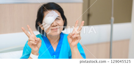 Elderly Woman with eye protective shield after eye surgery. Eye disease, Cataract, Glaucoma, Age Related Macular Degeneration, Diabetic Retinopathy, Vitreous, Lasik, World Glaucoma day and health Elderly Woman with eye protective shield after eye surgery. Eye disease, Cataract, Glaucoma, Age Related Macular Degeneration, Diabetic Retinopathy, Vitreous, Lasik, World Glaucoma day and health 129045525