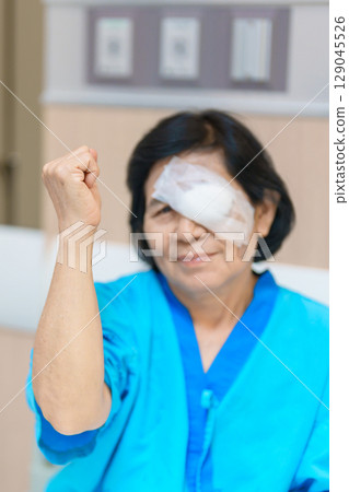 Elderly Woman with eye protective shield after eye surgery. Eye disease, Cataract, Glaucoma, Age Related Macular Degeneration, Diabetic Retinopathy, Vitreous, Lasik, World Glaucoma day and health Elderly Woman with eye protective shield after eye surgery. Eye disease, Cataract, Glaucoma, Age Related Macular Degeneration, Diabetic Retinopathy, Vitreous, Lasik, World Glaucoma day and health 129045526