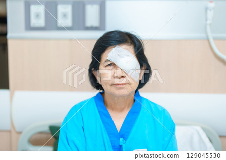 Elderly Woman with eye protective shield after eye surgery. Eye disease, Cataract,  Glaucoma, Age Related Macular Degeneration, Diabetic Retinopathy, Vitreous, Lasik, World Glaucoma day and health 129045530