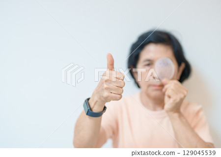 Elderly Woman with eye protective shield after eye surgery. Eye disease, Cataract,  Glaucoma, Age Related Macular Degeneration, Diabetic Retinopathy, Vitreous, Lasik, World Glaucoma day and health 129045539