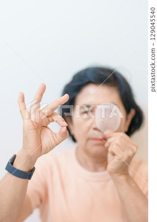 Elderly Woman with eye protective shield after eye surgery. Eye disease, Cataract,  Glaucoma, Age Related Macular Degeneration, Diabetic Retinopathy, Vitreous, Lasik, World Glaucoma day and health 129045540