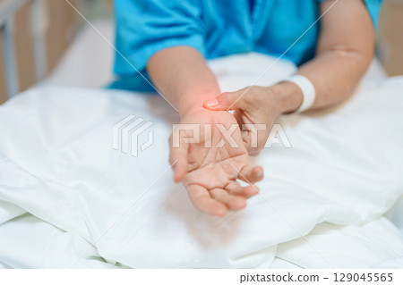 Elderly Patient  Woman having wrist pain in hospital, muscle ache due to Carpal Tunnel Syndrome, De Quervain s tenosynovitis, rheumatoid, arthritis, gout, Parkinson disease and ergonomic healthcare 129045565