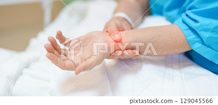 Elderly Patient  Woman having wrist pain in hospital, muscle ache due to Carpal Tunnel Syndrome, De Quervain s tenosynovitis, rheumatoid, arthritis, gout, Parkinson disease and ergonomic healthcare 129045566