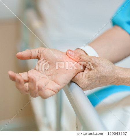 Elderly Patient Woman having wrist pain in hospital, muscle ache due to Carpal Tunnel Syndrome, De Quervain s tenosynovitis, rheumatoid, arthritis, gout, Parkinson disease and ergonomic healthcare 129045567