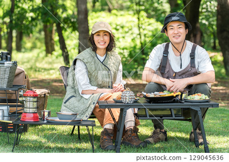 Couples, families, and couples enjoying camping at a campsite 129045636