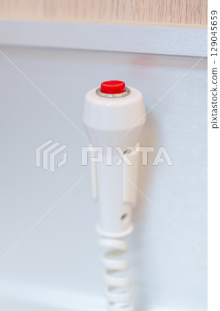 emergency button in hospital room, calling nurse in emergency case. Professional Medical system and Safety Alert emergency button in hospital room, calling nurse in emergency case. Professional Medical system and Safety Alert 129045659