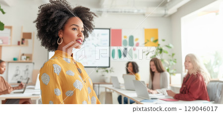Professional african american woman guiding multicultural creative team, collaborating in contemporary workspace, embodying leadership and workplace diversity 129046017