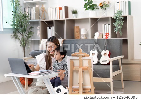 Mother and Child Enjoying Interactive Learning at Home 129046393