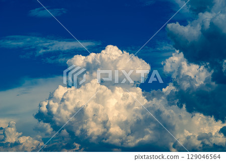 Summer sky with cumulonimbus clouds spreading out c-4 Warm and cool colors emphasized Summer sky with cumulonimbus clouds spreading out c-4 Warm and cool colors emphasized 129046564