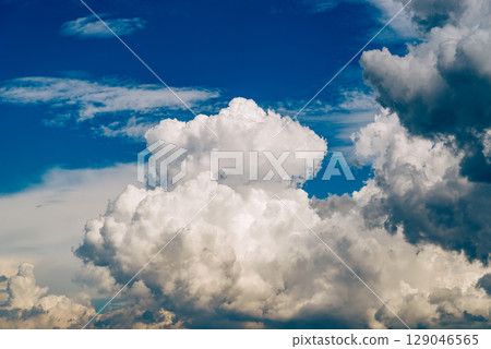Summer sky with cumulonimbus clouds spreading c-5 film style Summer sky with cumulonimbus clouds spreading c-5 film style 129046565