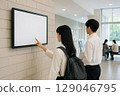 Students interacting with digital signage on a university campus 129046795