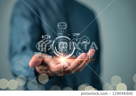AI brain digital interface is displayed on a man open palm hand, showing futuristic AI analysis and connecting to machine learning systems and technology AI brain digital interface is displayed on a man open palm hand, showing futuristic AI analysis and connecting to machine learning systems and technology 129046800