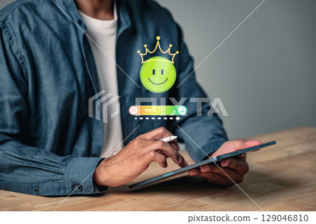 Customer feedback through an online survey shows user satisfaction and ratings as a man uses a tablet to provide a review after completing a survey for service quality control Customer feedback through an online survey shows user satisfaction and ratings as a man uses a tablet to provide a review after completing a survey for service quality control 129046810