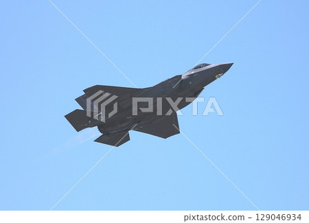 A US Air Force F-35A Lightning II stealth fighter jet flying in a clear blue sky A US Air Force F-35A Lightning II stealth fighter jet flying in a clear blue sky 129046934