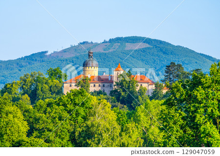 Nestled among lush greenery, Grabstejn Castle stands majestically against the backdrop of rolling hills in Czechia. Nestled among lush greenery, Grabstejn Castle stands majestically against the backdrop of rolling hills in Czechia. 129047059