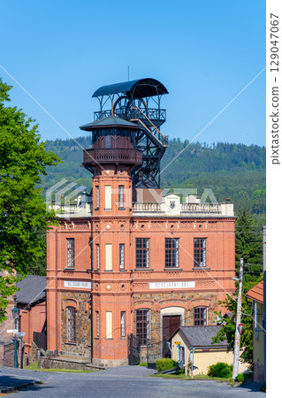 Sevcinsky mine in Brezove hory showcases its unique architecture under clear blue skies. The historic structure highlights the region's mining heritage and scenic landscape. 129047067