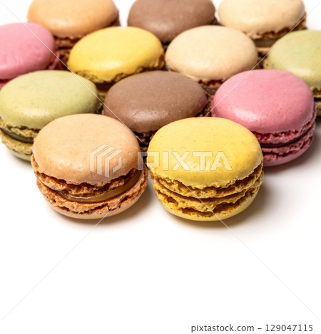 Small colorful tasty sweet original classic macaroons cakes isolated on white studio background Small colorful tasty sweet original classic macaroons cakes isolated on white studio background 129047115