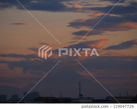 The faint silhouette of Mt. Fuji in the sunset sky 129047726
