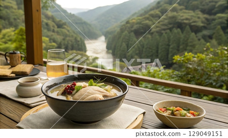 Soup and view on table with river and hills in the background outdoor area 129049151