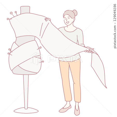 A Fashion Designer Draping and Arranging Elegant Fabric on a Dress Form for Creation A Fashion Designer Draping and Arranging Elegant Fabric on a Dress Form for Creation 129049286